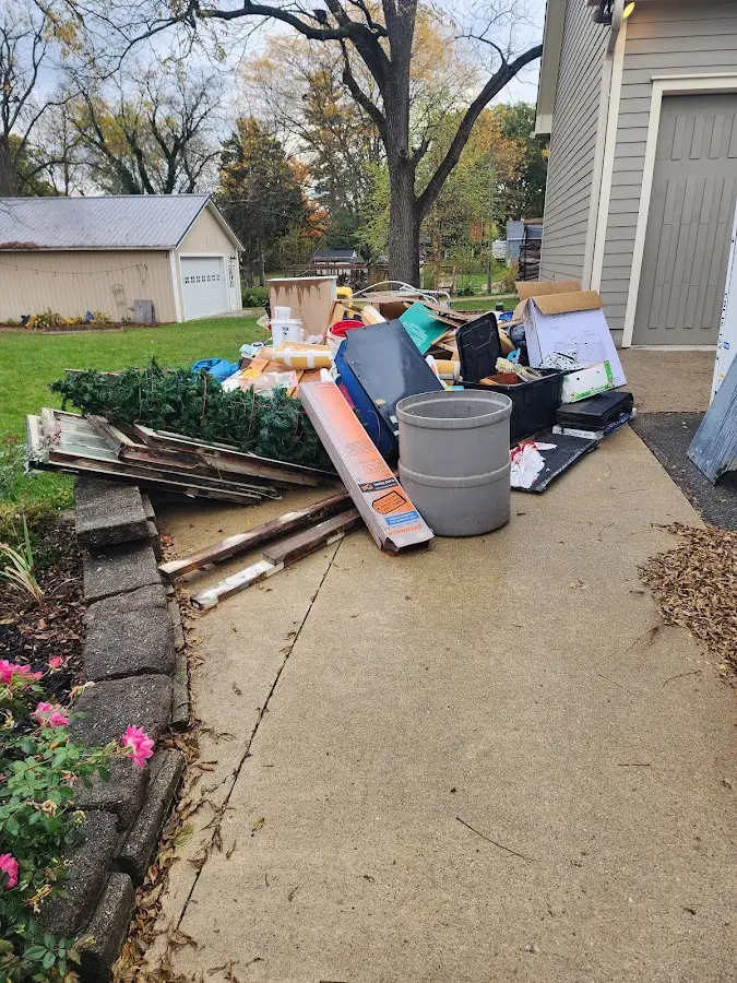 Dumpster being loaded with debris for 12 Yard Dumpster Rental in Clearview